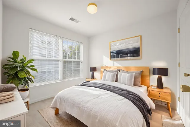 a bedroom with a bed and a window