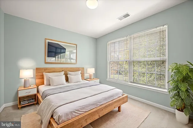 a bedroom with a large bed and a large window