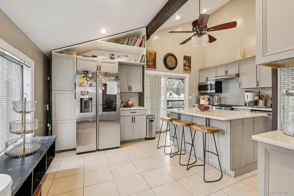 a kitchen with a sink stainless steel appliances and cabinets