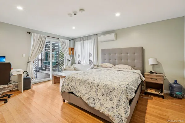 a spacious bedroom with a bed and large windows