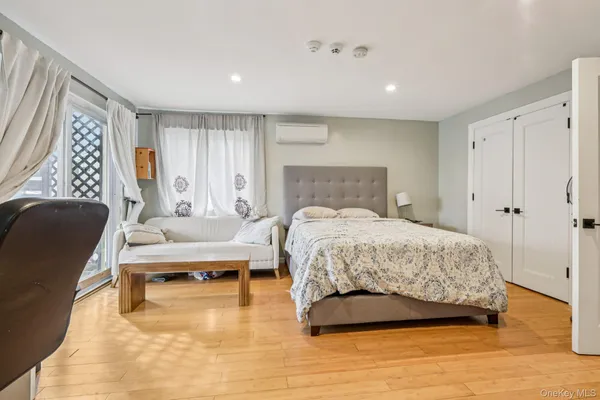 a bedroom with a bed and a couch