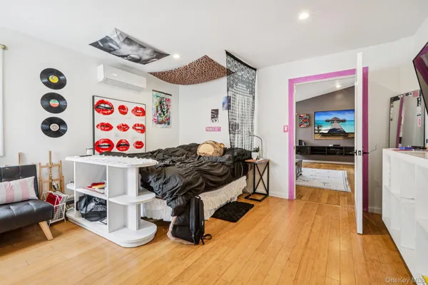 a bedroom with furniture and a wooden floor
