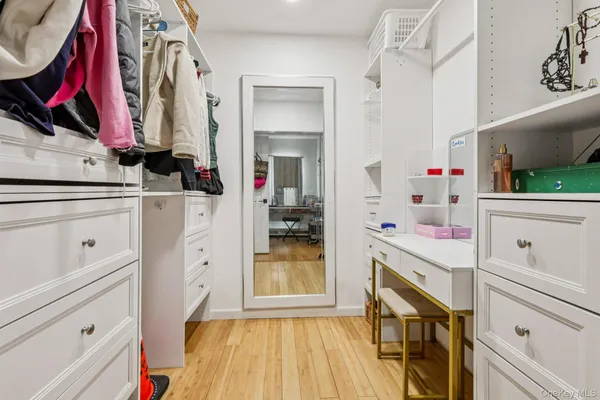 a kitchen with white cabinets and sink