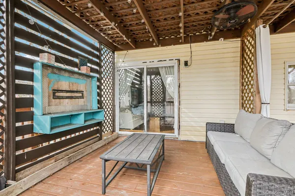 a backyard of a house with barbeque oven table and chairs