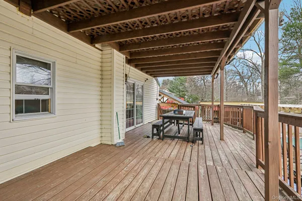 a view of a chairs and table on the wooden deck