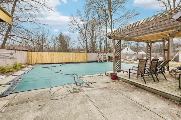 a view of backyard with table and chairs under an umbrella