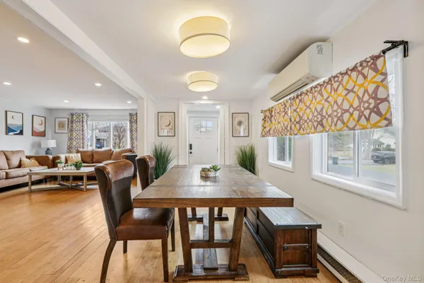 a view of a dining room with furniture window and wooden floor