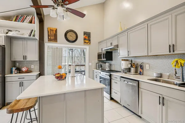 a kitchen with stainless steel appliances a white cabinets and a refrigerator