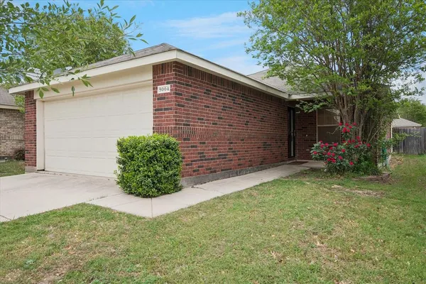 a backyard of a house with barbeque oven