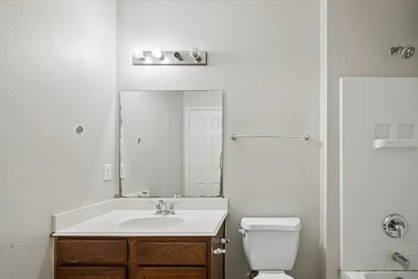 a bathroom with a sink a toilet and mirror