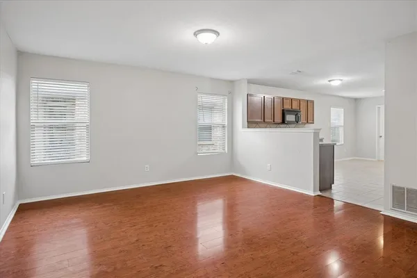a view of room with window and wooden floor