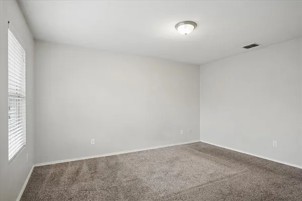 a view of an empty room and a window