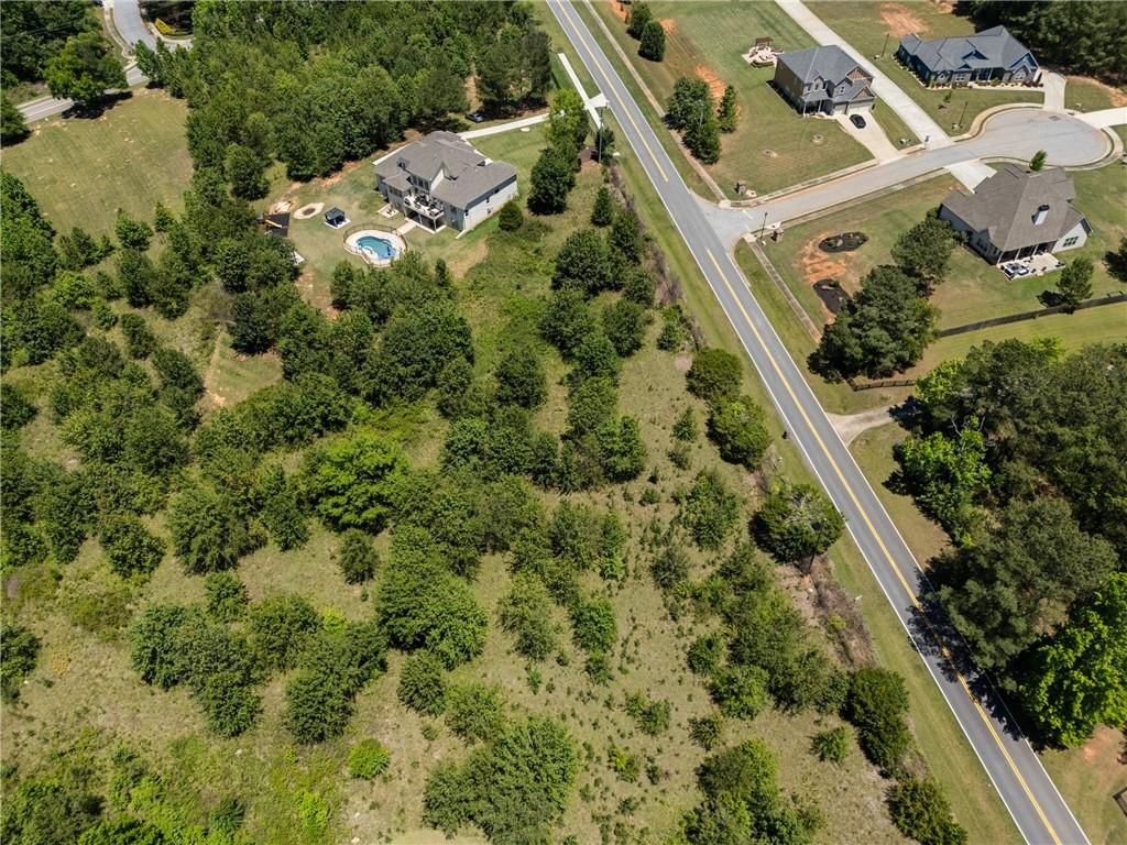 6707 Bishop Road Fairburn, GA 30213 - Photo 4 of 10 an aerial view of residential house with outdoor space and trees all around