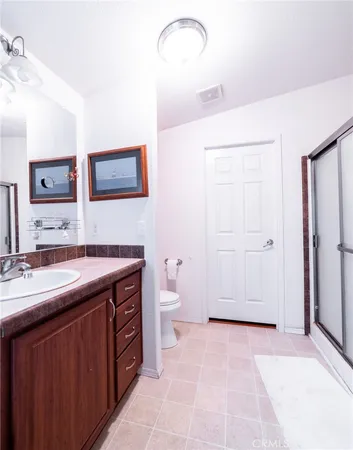 a spacious bathroom with a granite countertop sink toilet and shower
