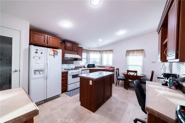 a view of kitchen with stainless steel appliances granite countertop lots of counter top space