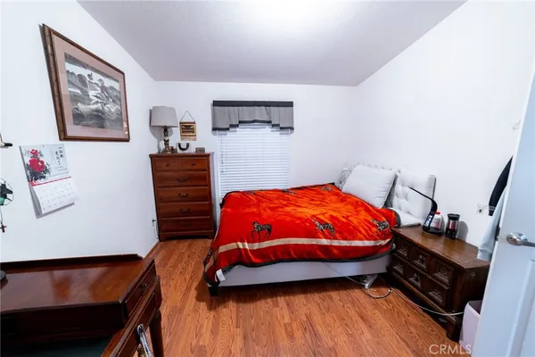 a bedroom with a bed and dresser