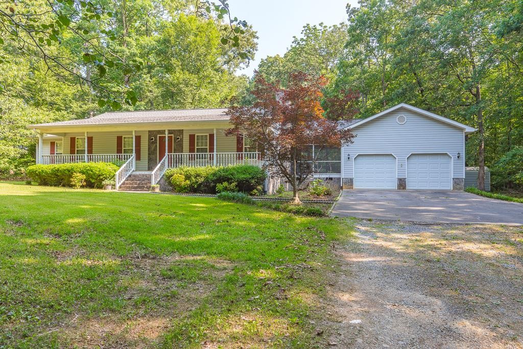 a front view of house with yard and green space