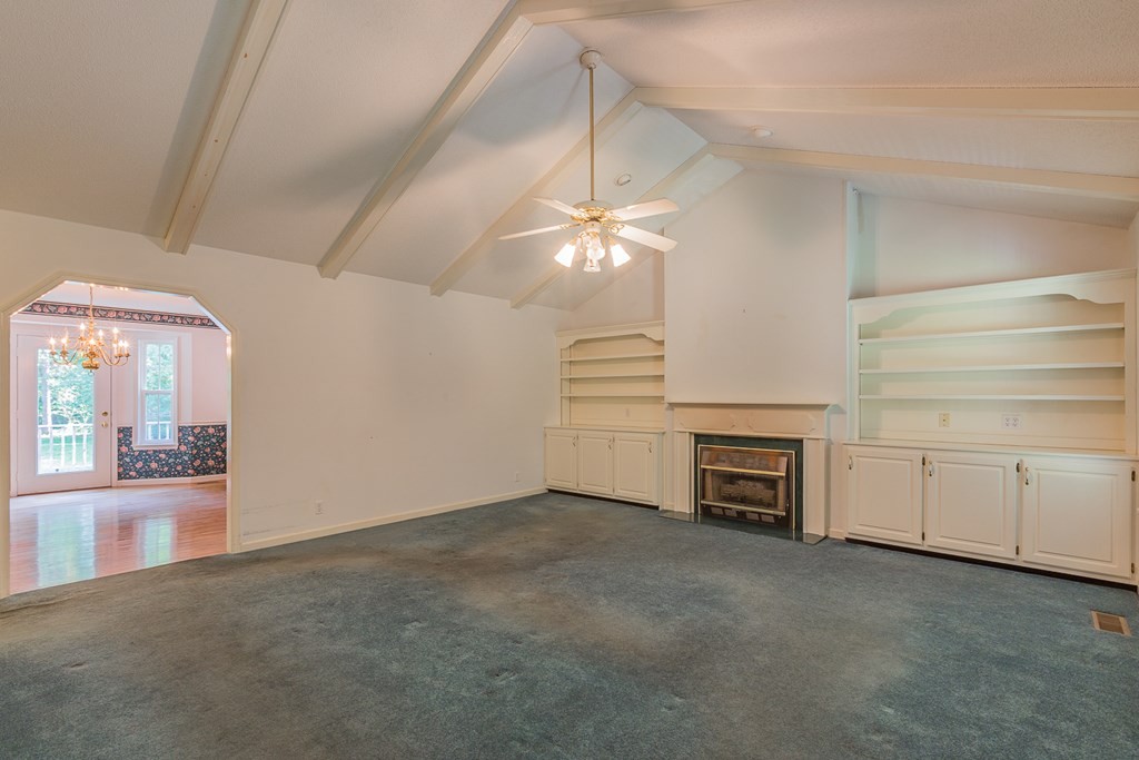 311 Johnson Road Chatsworth, GA 30705 - Photo 18 of 46 wooden floor in an empty room with a fireplace
