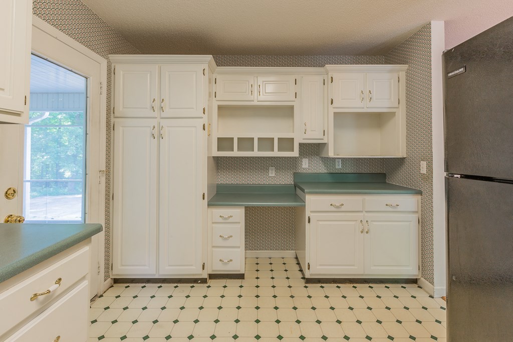 311 Johnson Road Chatsworth, GA 30705 - Photo 26 of 46 a kitchen with granite countertop white cabinets and appliances