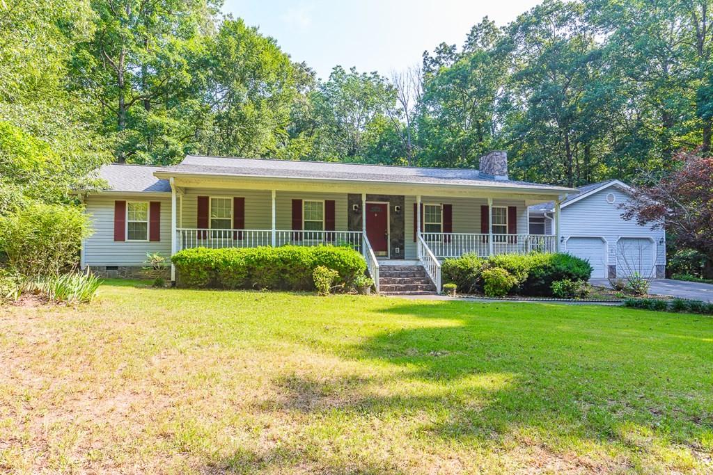 311 Johnson Road Chatsworth, GA 30705 - Photo 6 of 46 a view of a house with a backyard