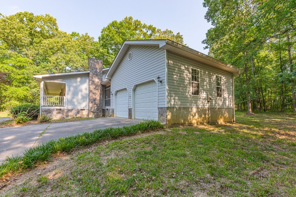 311 Johnson Road Chatsworth, GA 30705 - Photo 8 of 46 a front view of a house with a yard