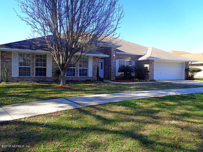 2444 Mallory Hills Road Jacksonville, FL 32221 - Photo 1 of 40 a view of a house with a big yard and large trees