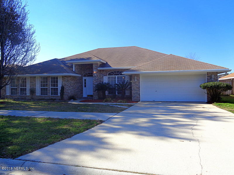 2444 Mallory Hills Road Jacksonville, FL 32221 - Photo 2 of 40 a front view of a house with garden
