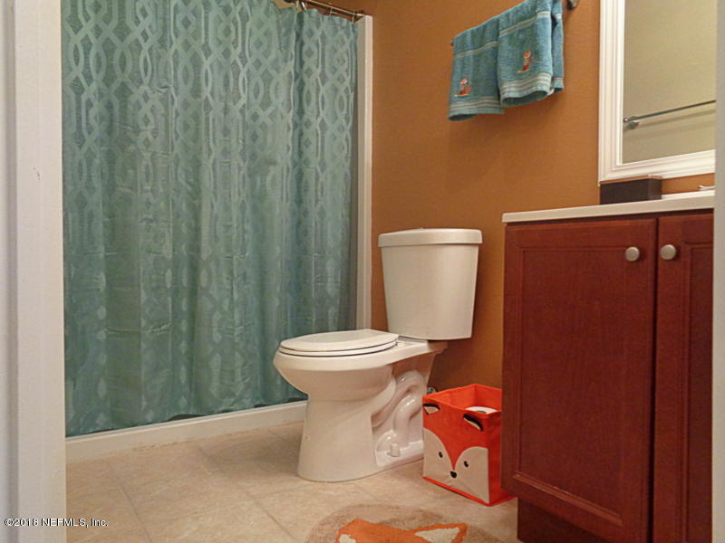 2444 Mallory Hills Road Jacksonville, FL 32221 - Photo 32 of 40 a white toilet sitting next to a small sink