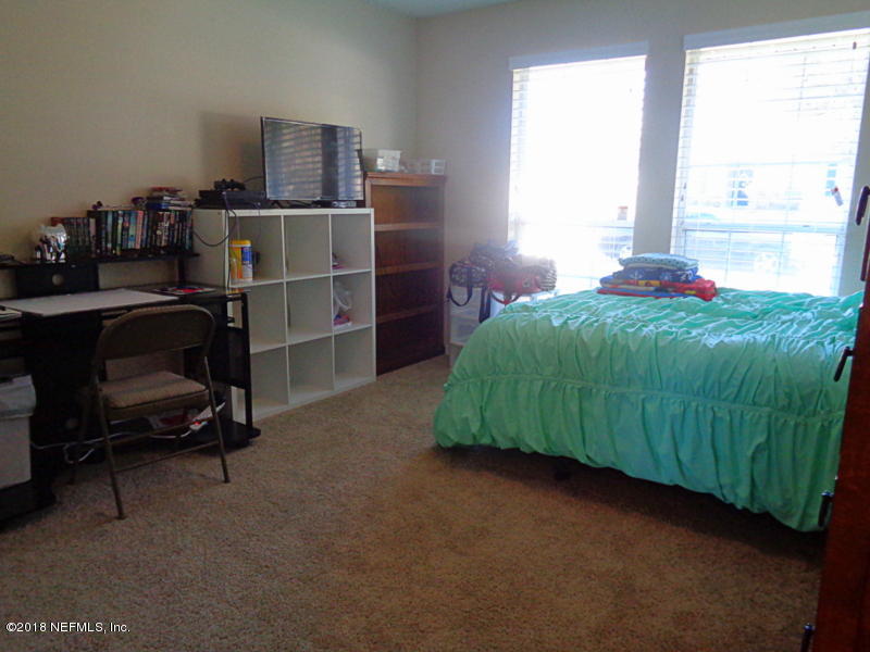 2444 Mallory Hills Road Jacksonville, FL 32221 - Photo 35 of 40 a living room with a bed furniture and a window