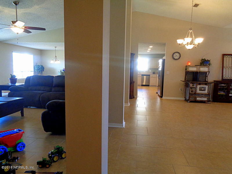 2444 Mallory Hills Road Jacksonville, FL 32221 - Photo 8 of 40 a view of a livingroom with furniture and chandelier