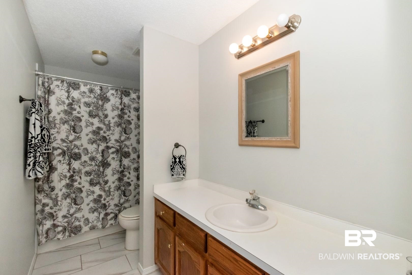 9991 Wedgefield Court Mobile, AL 36608 - Photo 21 of 30 Bathroom with vanity, tile patterned flooring, and toilet