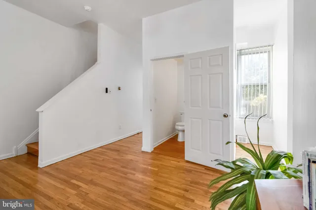a view of an empty room and wooden floor