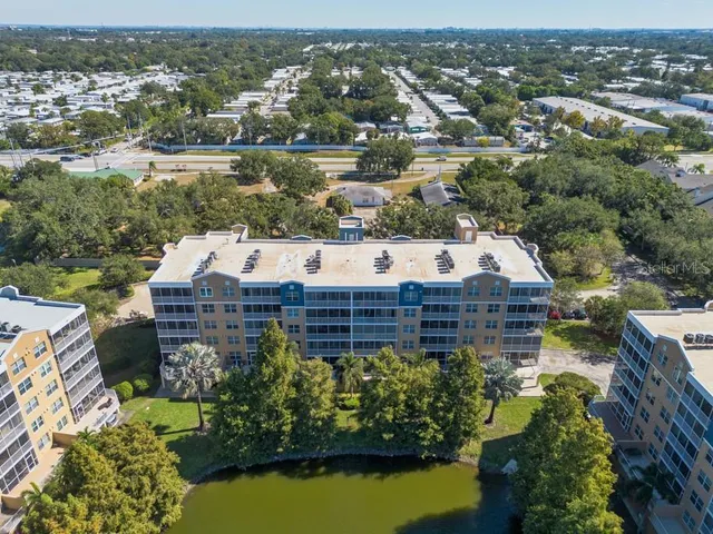 an aerial view of residential building with outdoor space and lake view