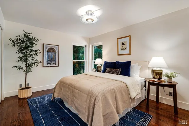a bedroom with bed and a potted plant