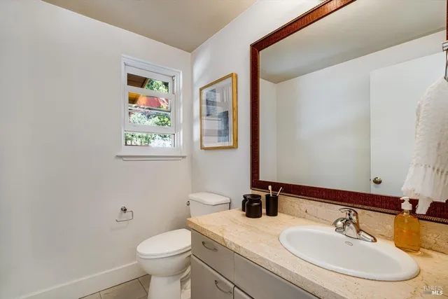 a bathroom with a toilet a sink and a mirror