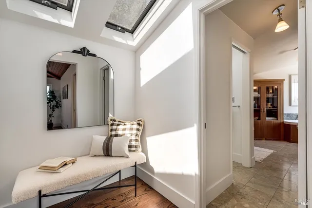 a view of a hallway with furniture and closet