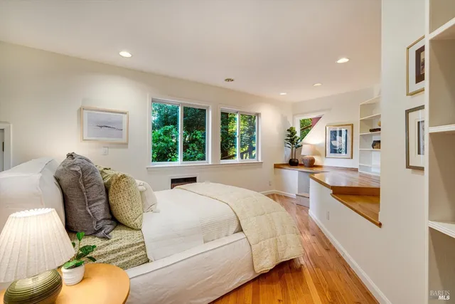 a bed room with two beds and a large window