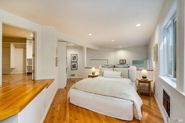 a view of empty room with wooden floor and cabinet
