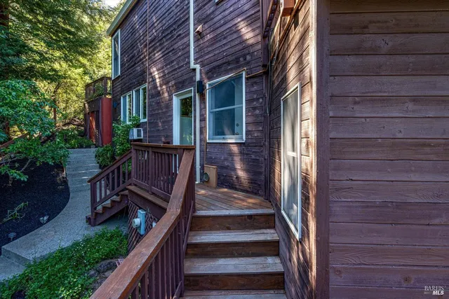 a backyard of a house with wooden floor and outdoor seating