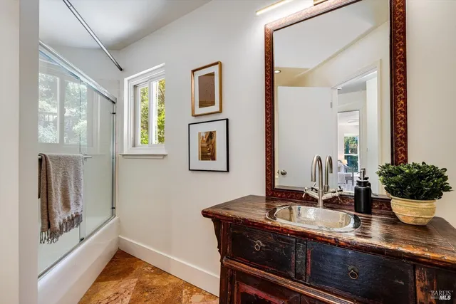a bath room with sink and mirror