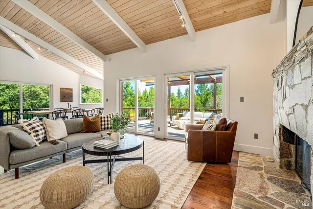 a living room with furniture fireplace and a large window