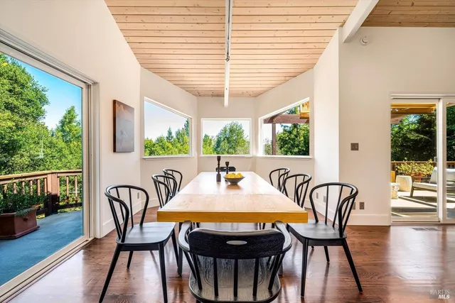 a outdoor dining space with furniture and wooden floor