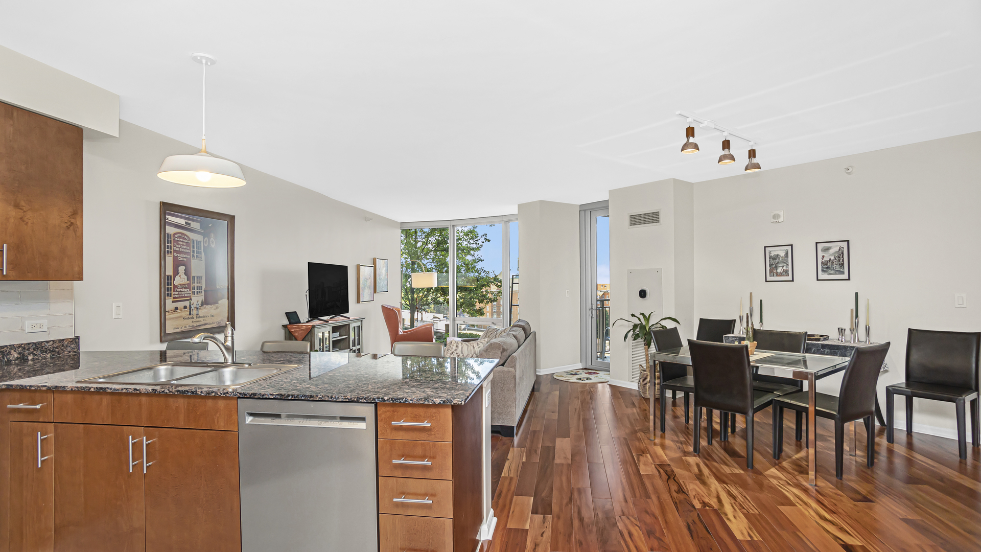 807 Davis Street, Unit 808 Evanston, IL 60201 - Photo 4 of 14 a dining hall with stainless steel appliances granite countertop a dining table and chairs with wooden floor