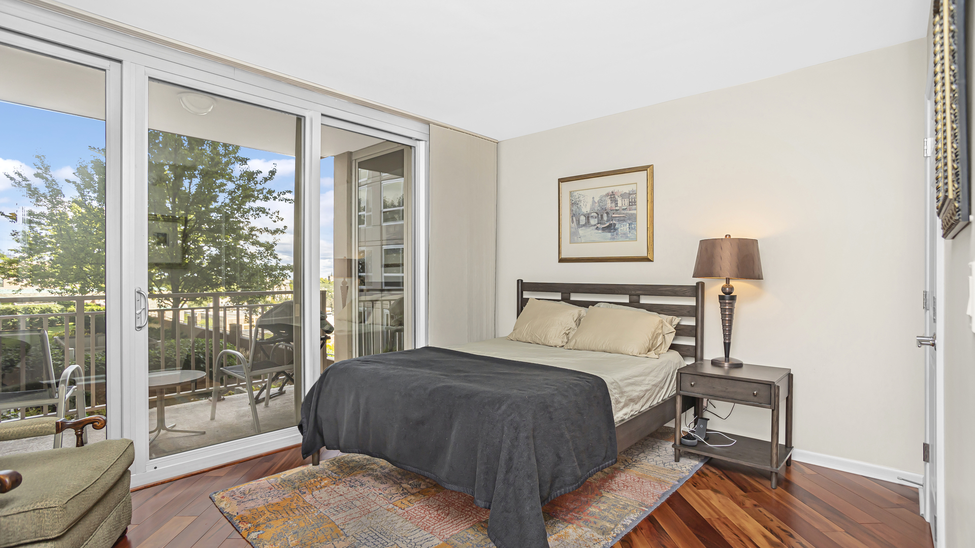 807 Davis Street, Unit 808 Evanston, IL 60201 - Photo 8 of 14 a bedroom with a bed a couch and large window