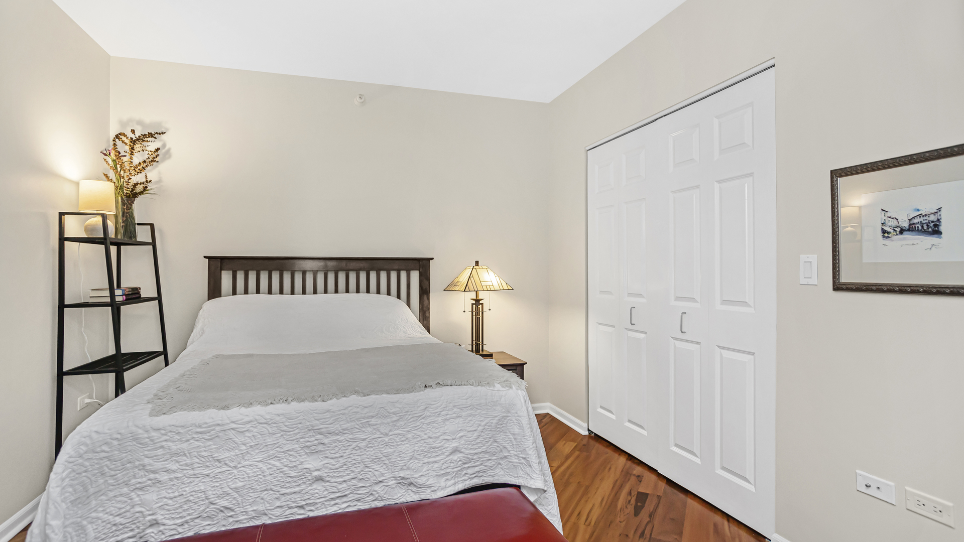 807 Davis Street, Unit 808 Evanston, IL 60201 - Photo 10 of 14 a view of a bedroom with wooden floor and a potted plant