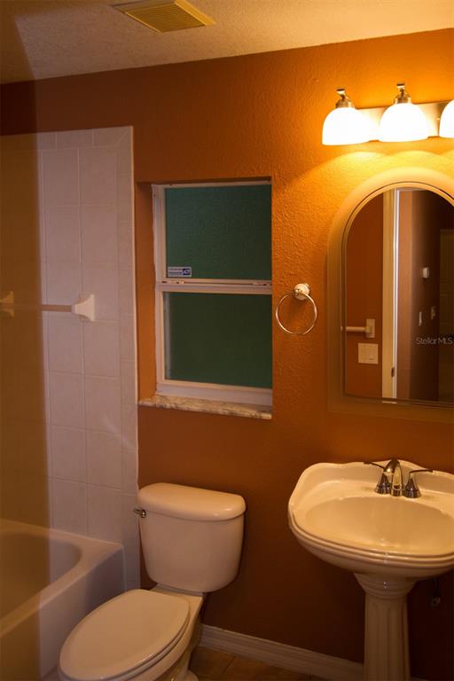 3092 Oklahoma Street North Port, FL 34286 - Photo 11 of 13 a bathroom with a toilet a sink and mirror
