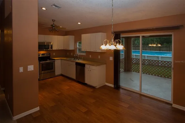 a kitchen with stainless steel appliances granite countertop a stove and a refrigerator