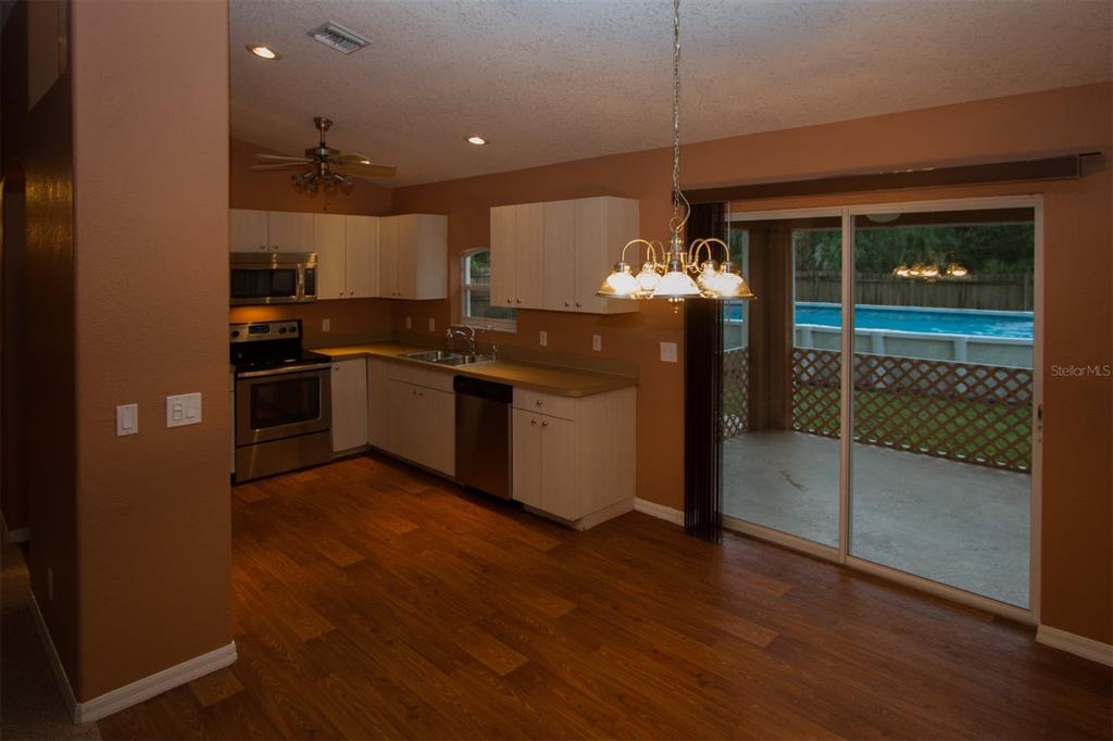 3092 Oklahoma Street North Port, FL 34286 - Photo 6 of 13 a kitchen with stainless steel appliances granite countertop a stove and a refrigerator
