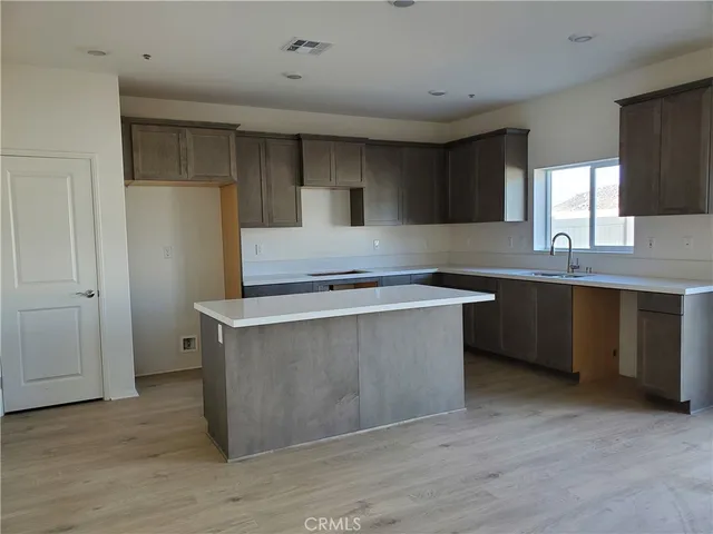 a kitchen with stainless steel appliances a sink stove and cabinets