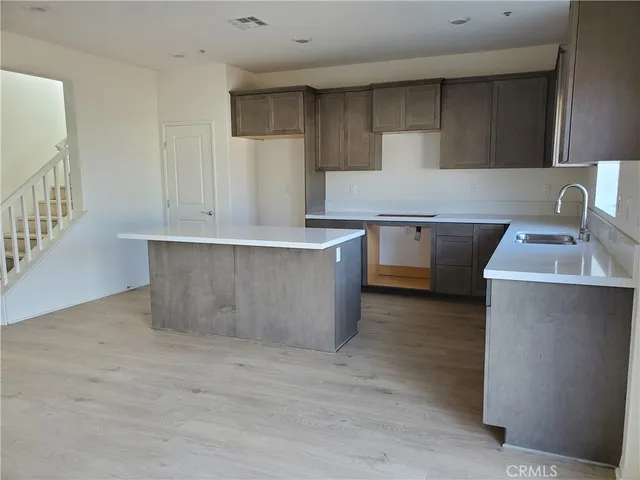 a kitchen with stainless steel appliances a sink stove and cabinets